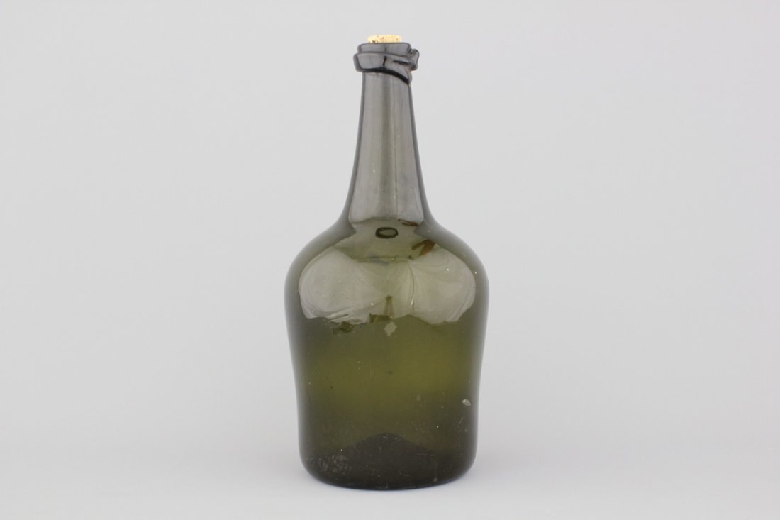 A large green glass blown bottle, 18th C.: H: 43 cm