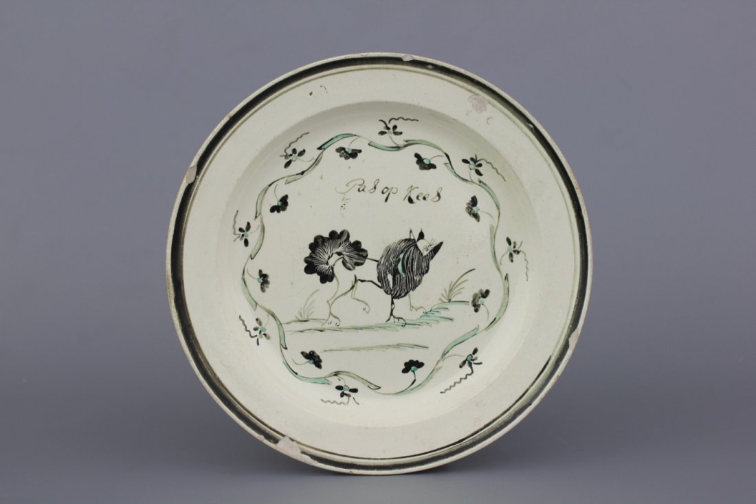 A Dutch-decorated English Leeds orangist creamware: Dia.: 21 cm, inscribed "Pas op Kees"
