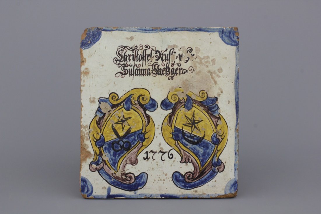 A German armorial stove tile, dated 1776 and inscribed: Dim.: 24 x 22 x 8 cm