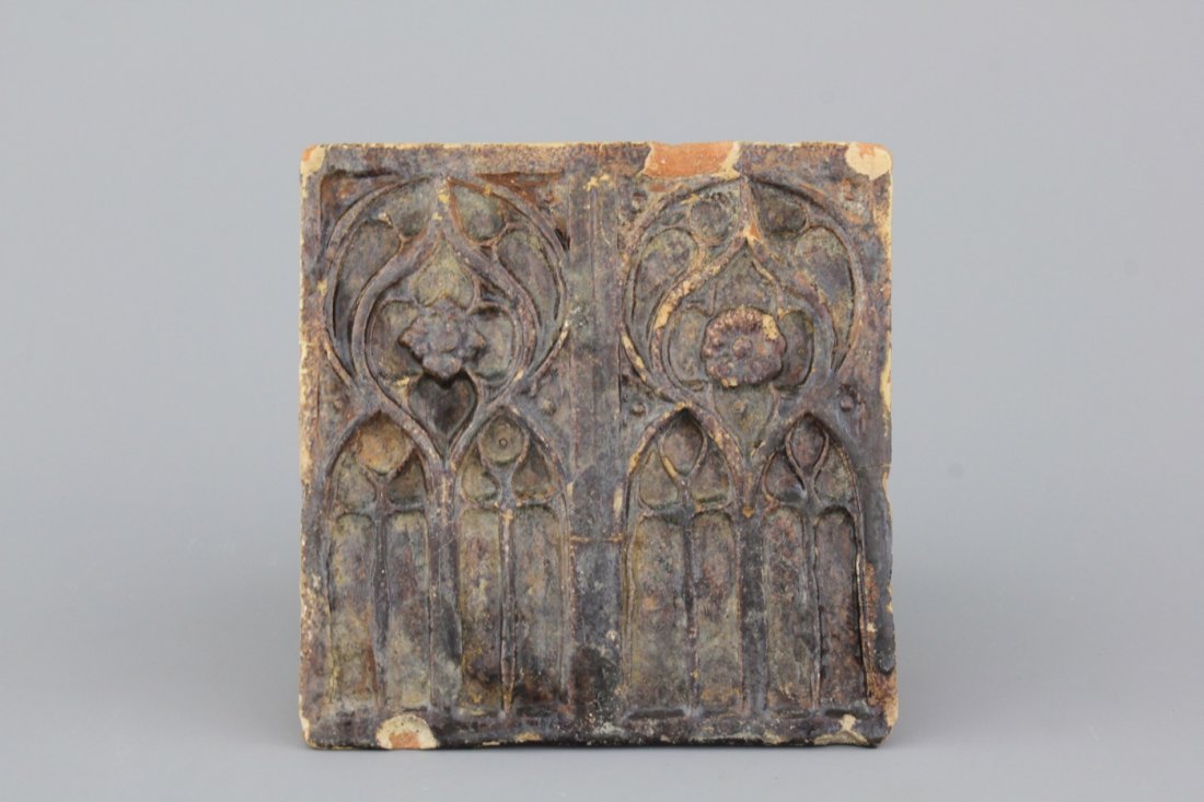 A German brown-glazed architectural stove tile, 16th .: Ca. 18 x 17,5 x 7,5 cm.