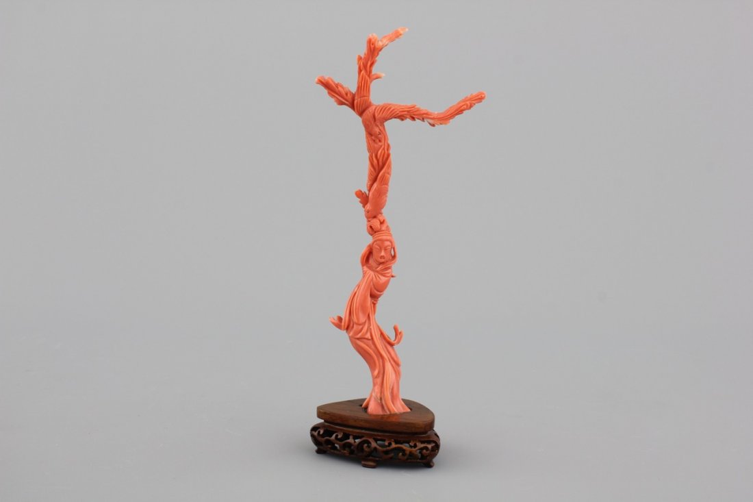 A fine sculpted Chinese red coral branch with a: H: 20 cm (incl. wood stand)