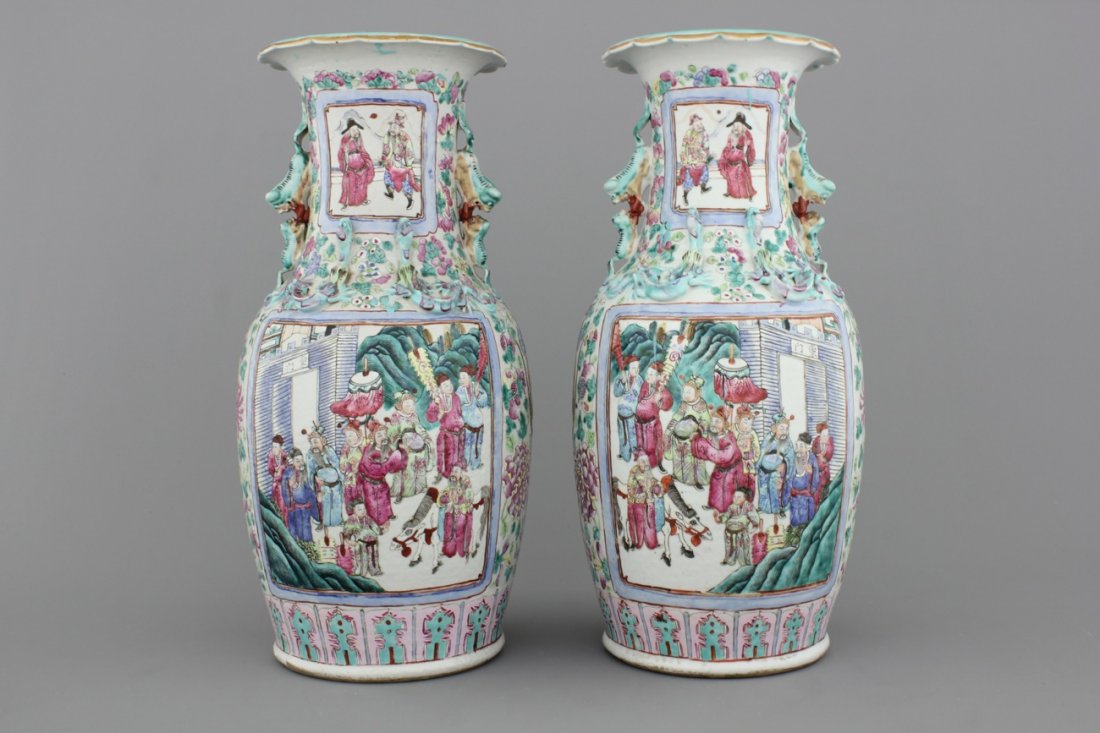 A pair of Chinese porcelain famille rose vases with: H: 46 cm. One with a restored chip on the top rim