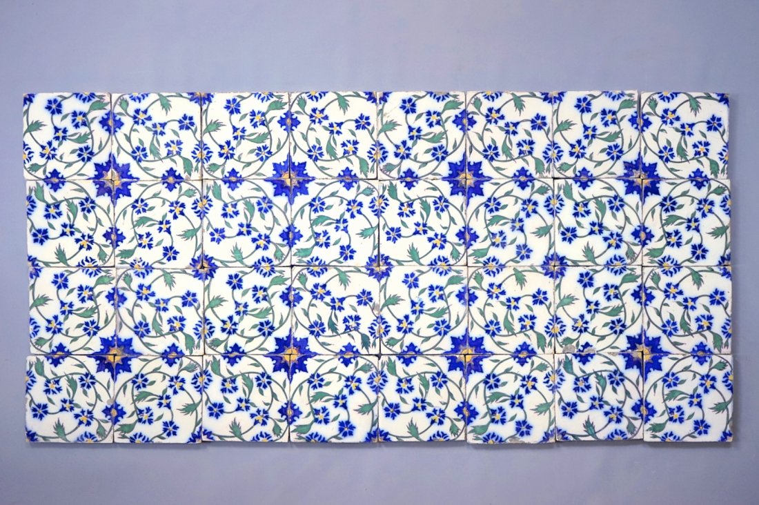 A set of 32 French tiles in Persian or Iznik style,: Dim.: 15 x 15 cm each Marked on the back with an impressed stamp.