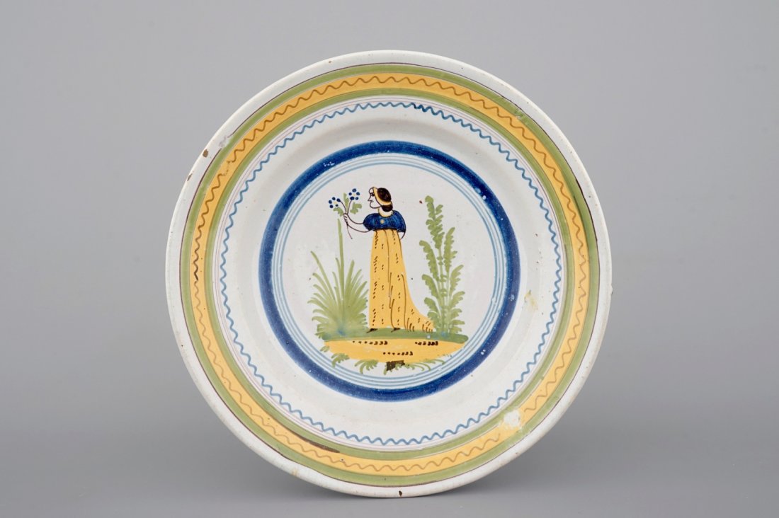 A Brussels faience plate with a lady, 18th C. (1 of 2)