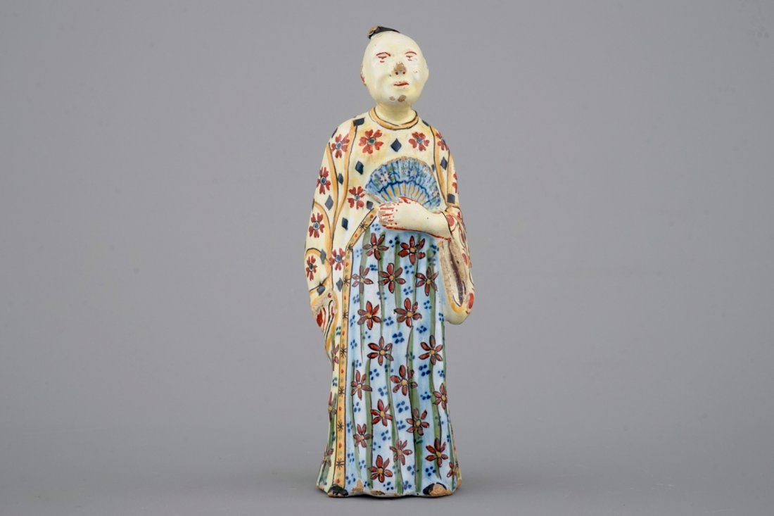 A yellow ground polychrome Dutch Delft figure of a (1 of 6)