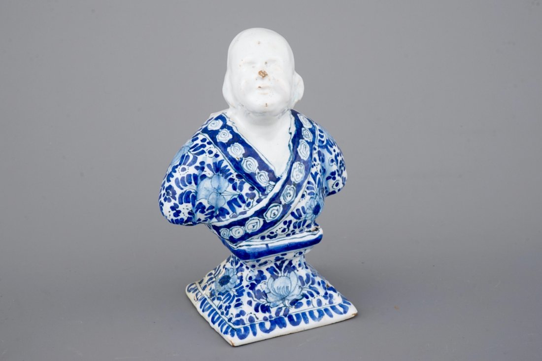 A Berlin faience blue and white bust of a chinaman,: H: 16,5 cm Condition: Some old repairs as visible.