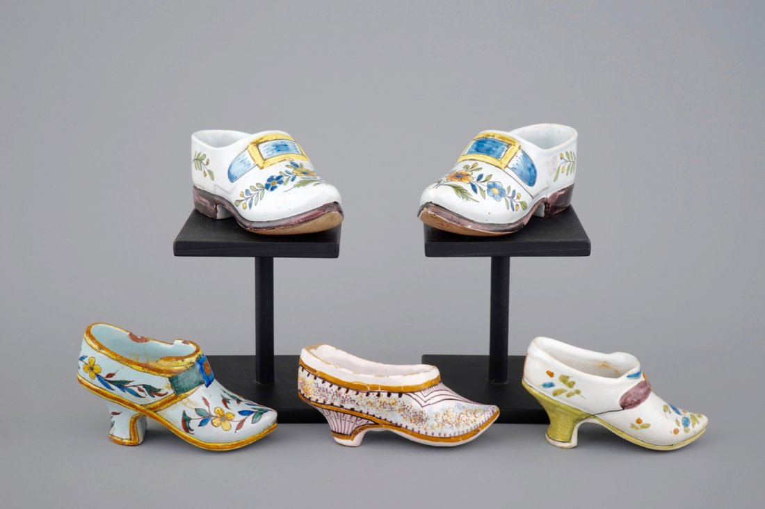 A small collection of French faience shoes, 18/19th C.: L: 16 cm (the longest) Comprising one pair and 3 individual examples.