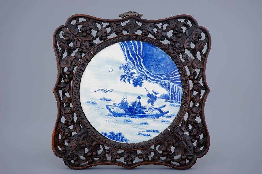 A Chinese blue and white plaque in sculpted frame, 19th: A Chinese blue and white plaque in sculpted frame, 19th C. The frame: Dim.: 44 x 44 cmThe tile: Dia.: 29 cm