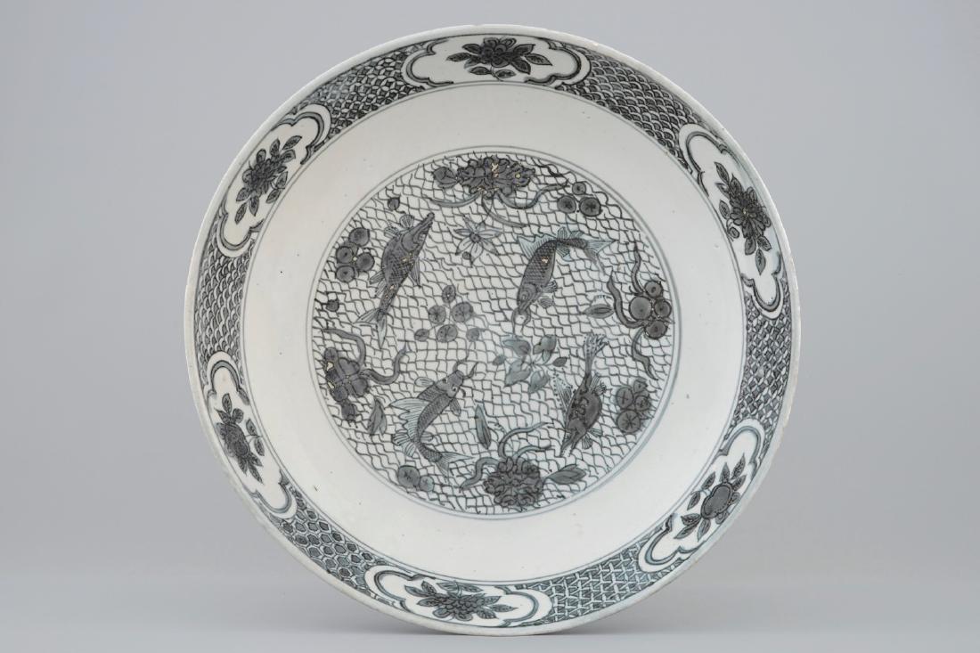 A Chinese Swatow dish with a blue-grey design of fish, (1 of 3)