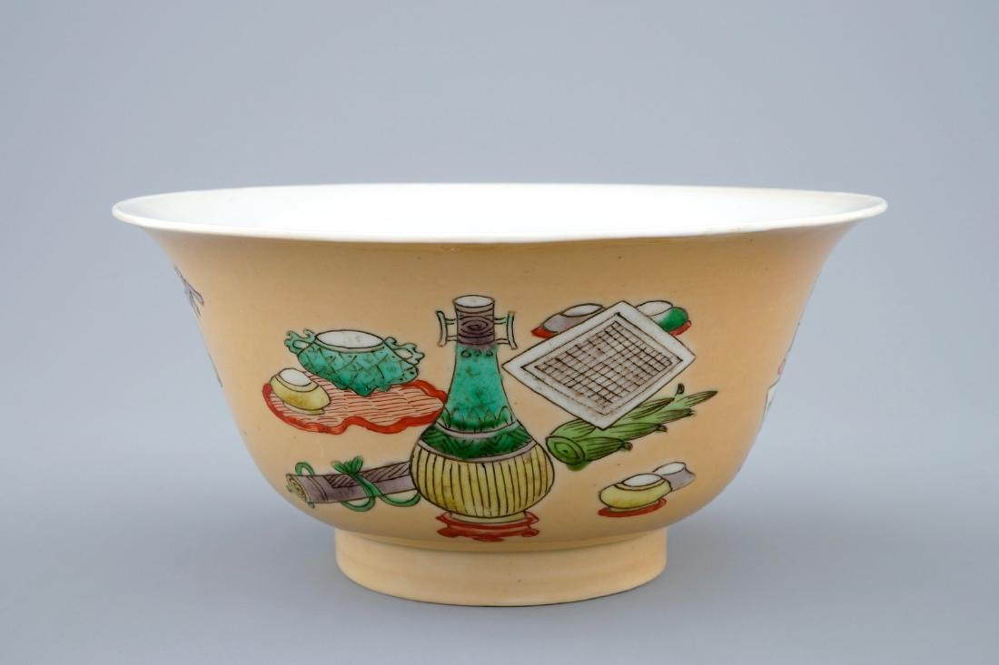 A Chinese famille verte cafŽ au lait ground bowl with: A Chinese famille verte cafŽ au lait ground bowl with precious objects, Kangxi Dia.: 16 cm - H.: 7,5 cm