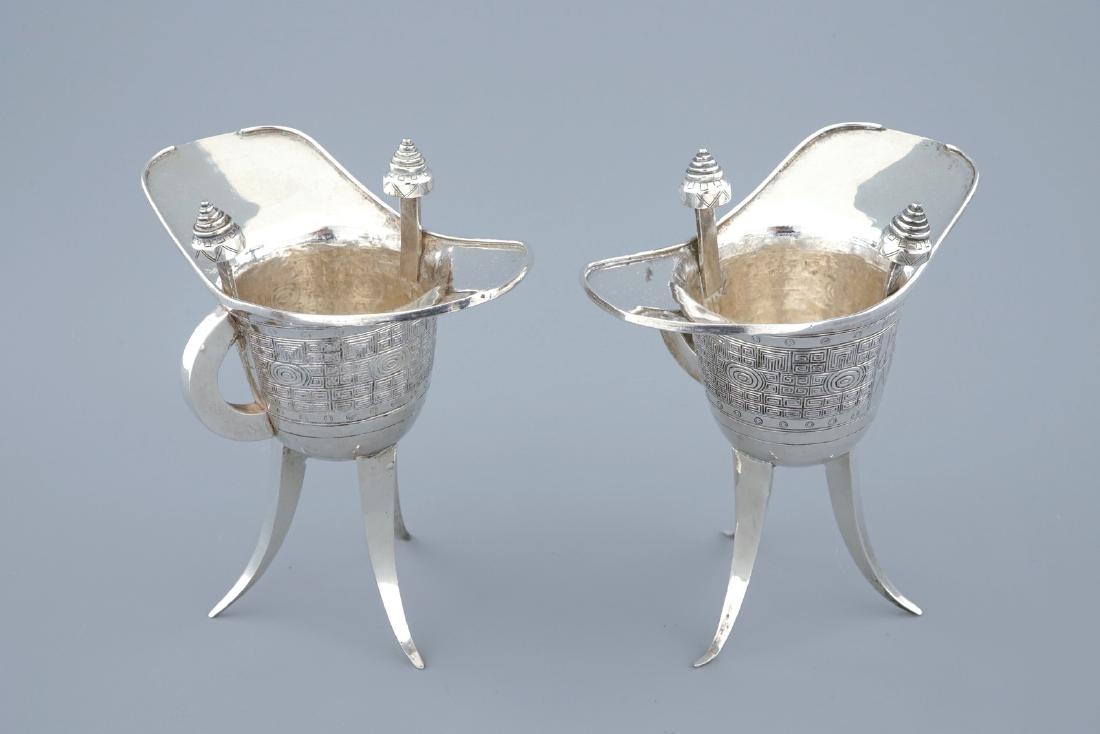 A pair of Chinese silver archaic "Jue" wine cups marked: A pair of Chinese silver archaic "Jue" wine cups marked for Heng Li, Tientsin, 19th C. H.: 12 cm