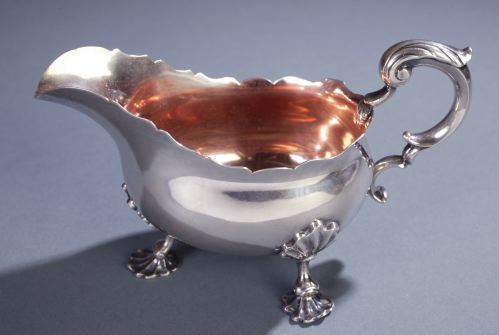 A SILVER GRAVY BOAT George B Sharp, Philadelphia: A SILVER GRAVY BOAT George B Sharp, Philadelphia ca. 1860 The oblong body with a scalloped edge and cast scroll handle on three cast and chased shell-pad feet. Marked beneath GEORGE SHARP/STERLING and