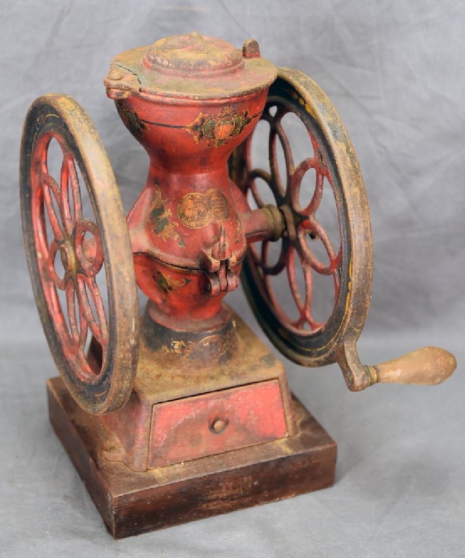 Enterprise Iron Coffee Grinder Dated XXVI: Columbian Exposition. 500Made in Philadephia. There is damage to the lid. Retains original decals and red paint. 13 1/2" tall.