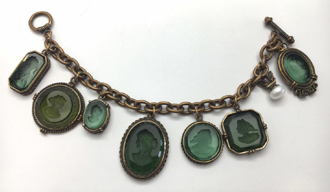 Extasia Green Glass Intaglio Charm Bracelet: Green glass intaglios in an antiqued gold metal setting. 7 1/2" long. Signed.