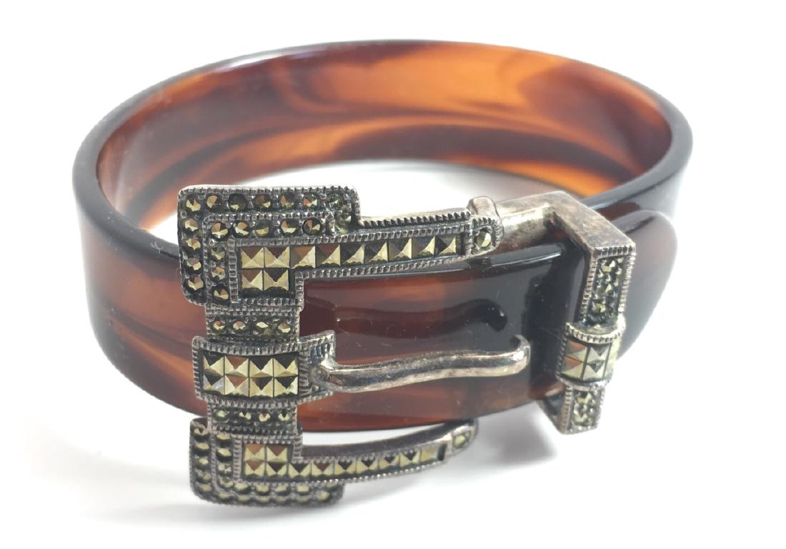 Sterling and Marcasite Buckle Tortoise Bracelet: A chic vintage bracelet, tortoiseshell plastic with a sterling silver with marcasite "belt" buckle. The buckle is marked sterling.