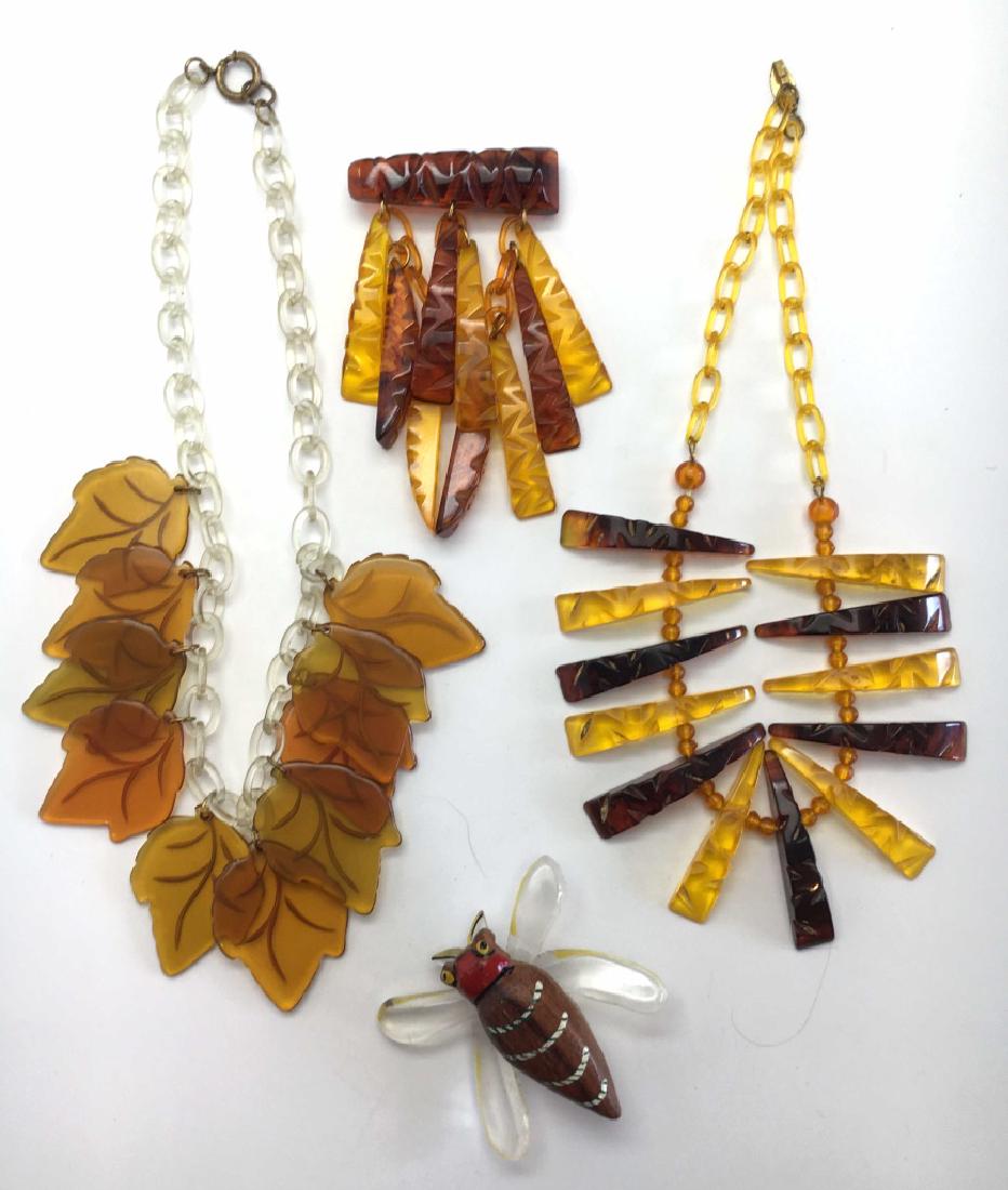1930s-40s Carved Bakelite & Celluloid Jewelry: Includes a carved brooch - 4" long, a matching necklace - 16" long, a carved leaf necklace and a whimsical acrylic and wood insect pin.