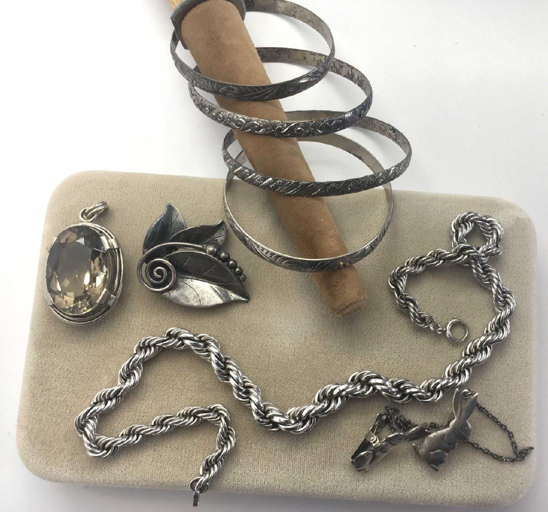 Vintage Sterling Silver Jewelry Lot: Includes a Lapaglia for International leaf brooch - 1 3/4" across, a heavy rope chain - 16" long, 4 engraved bangles, a large simulated topaz pendant and a rabbit themed sweater clip.