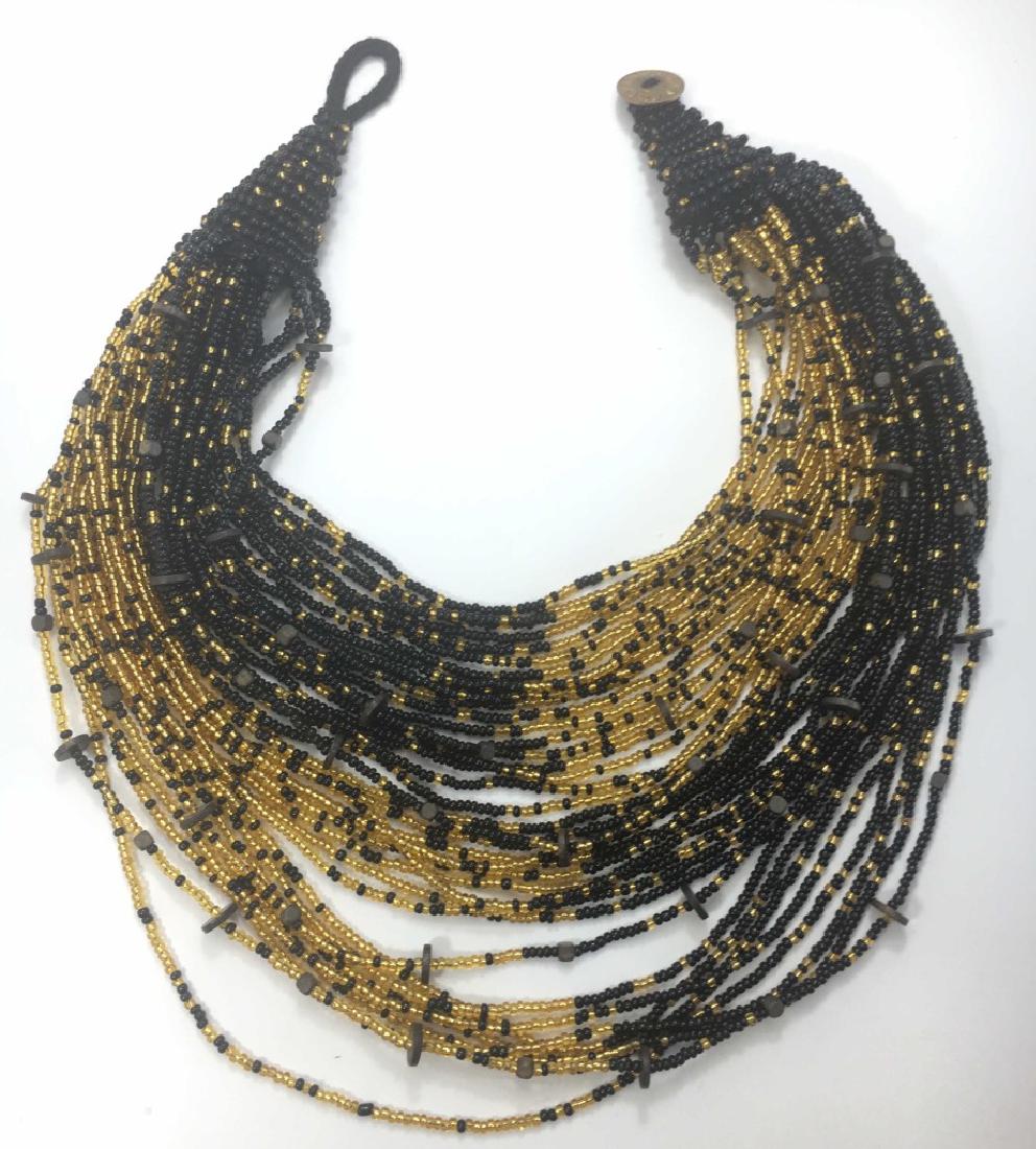 Dramatic Beaded Bib Necklace, Abacus, Jane Bedford: Truly a statement piece, artist made by Jane Bedford for Abacus in a Zulu inspired design. It measures approximately 18" in length. Handcrafted wooden stand is includes. Signed.