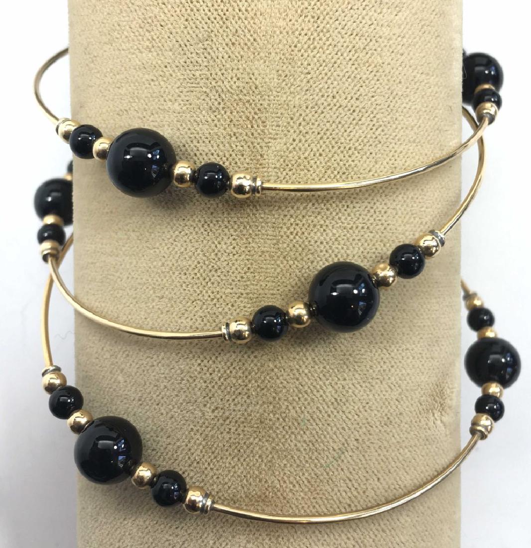 3 Gold and Black Onyx Bangle Bracelets: Black onyx beads with gold spacers, unmarked but possibly 14K.