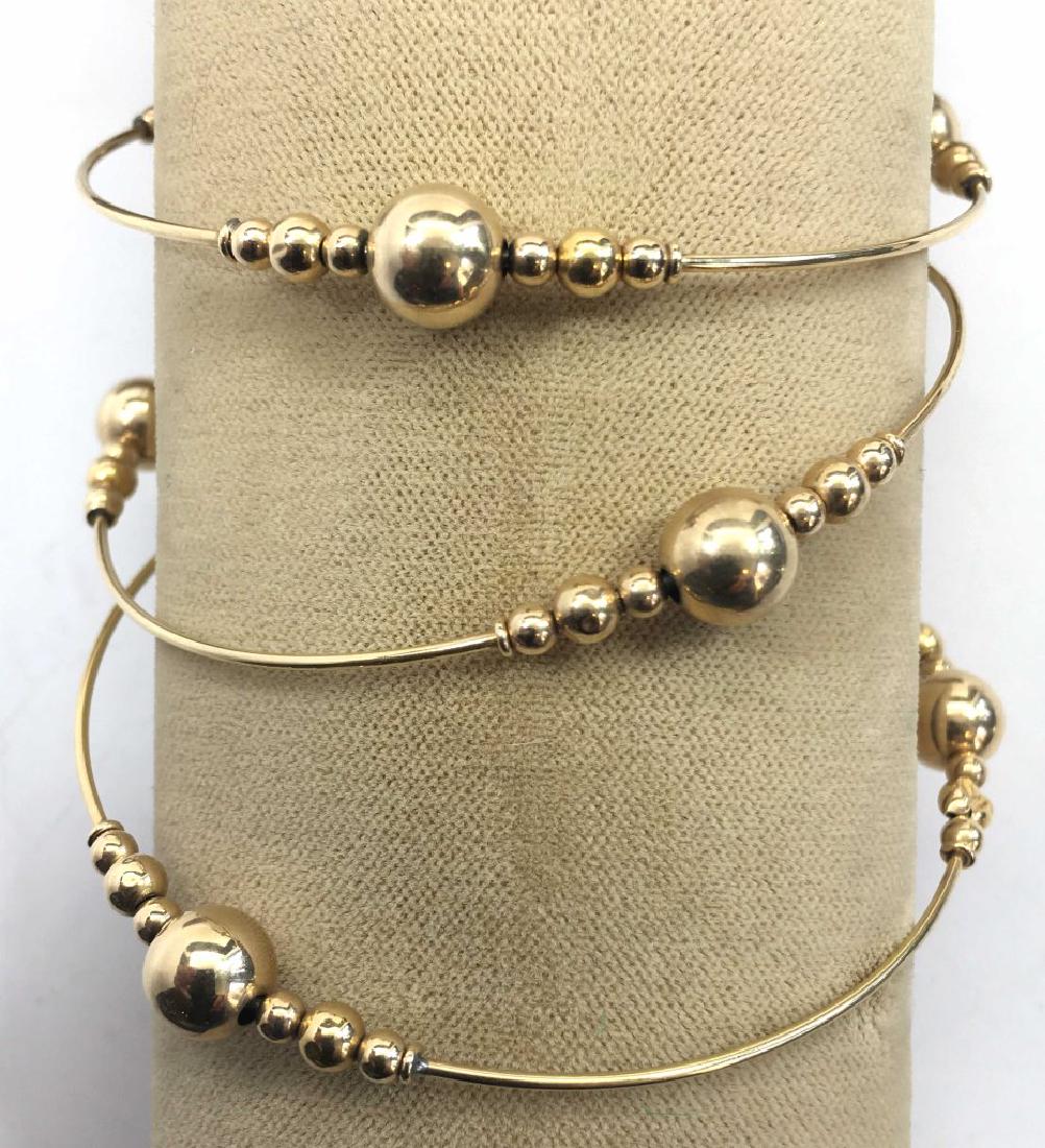 3 Gold Bead Bangle Bracelets: Unmarked but possibly 14K. Condition: There is some damage to some of the gold ball spacers on one of the bracelets.