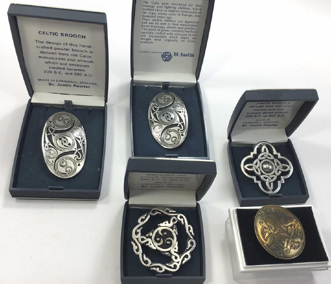 4 St. Justin Pewter Celtic Brooches: In their original boxes, the largest is approximately 2 1/4" wide. Also includes a brass Celtic brooch.