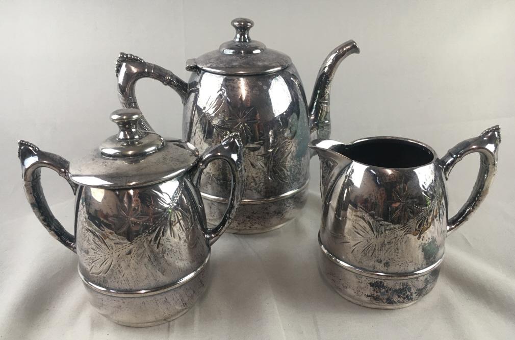 Victorian Triple Plate Silver Tea Set A pretty small: A pretty small sized set with an etched design. The teapot measures approximately 7 3/3” tall. It is marked “United States Plating Co. Triple Plate”. It is in very good condition.