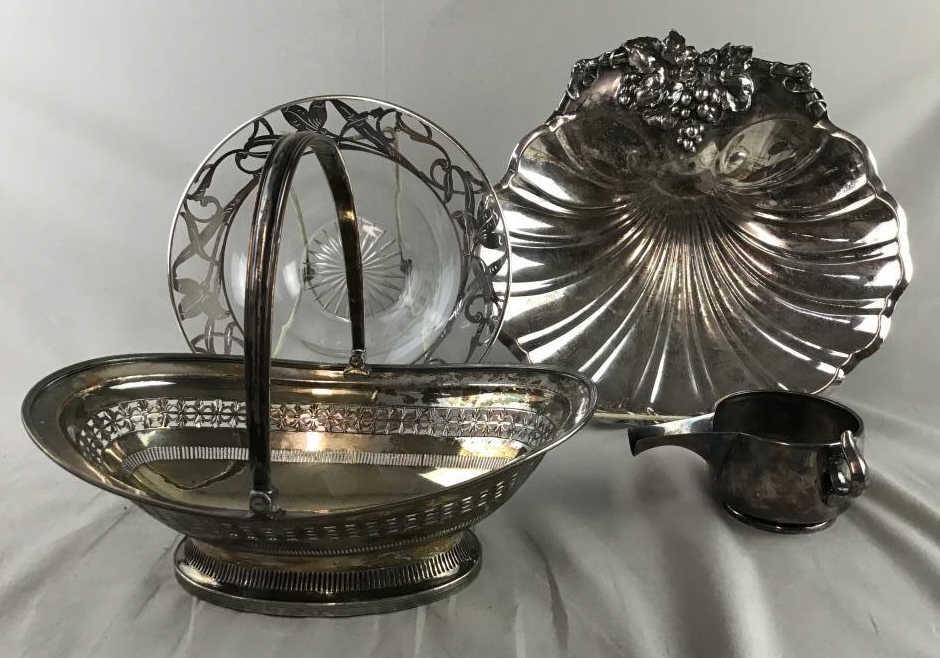 4 Silver Plated Serving Pieces, Reed & Barton Includes: Includes a large and heavy Reed & Barton shell shaped bowl with grape decoration which measures approximately 11 3/4" wide. Also includes a fruit basket , a crystal bowl with silver overlay (a bit of