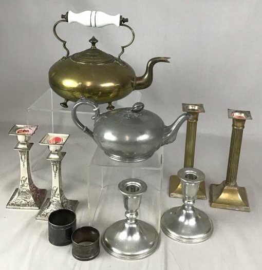 Vintage Decorative Metal Tableware Includes teapots in: Includes teapots in brass and pewter, 3 pairs of candlesticks in pewter and Silver Plate and 2 silver plate napkin rings.