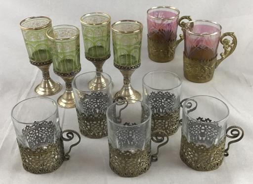 Ornate Glassware - Turkey, Morocco, Russia Includes 3: Includes 3 wonderful sets. The pair of cut cranberry flash tea glasses in brass holders are Russian. They measure approximately 3 1/2" tall. The 4 green and gold painted glasses on silver stems are fr