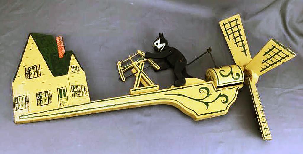 1930s Folk Art Felix the Cat Whirligig: Original paint on wood, appears to be marked "Vigneault Handy Shop". Measures approximately 26" long. It is missing one of its blades but seems to be otherwise operational.