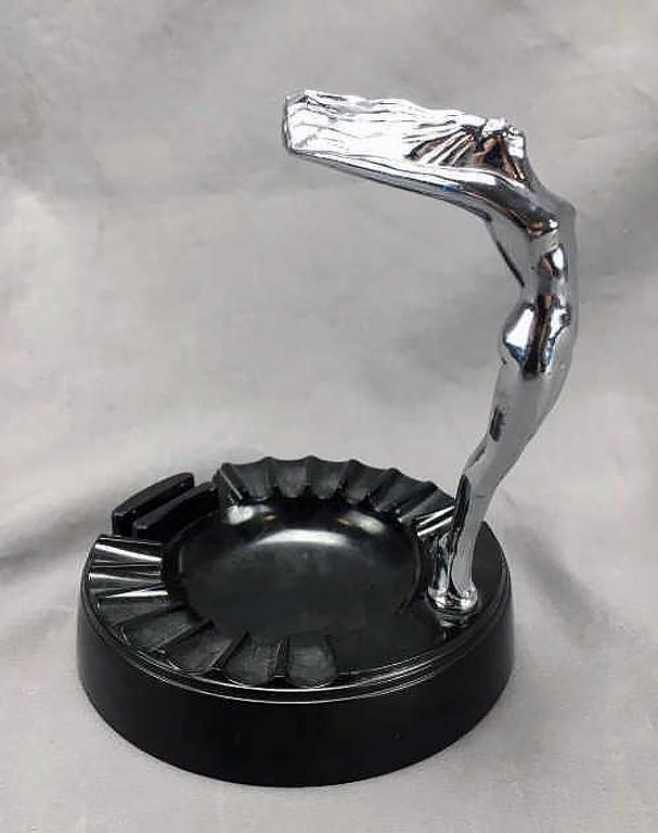Tops Daka Ware Figural Nude Ashtray: In Bakelite and chrome. Measures approximately 6" tall.