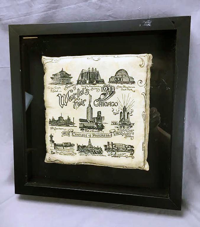 1933 Chicago World's Fair Souvenir Pillow: Century of Progress, framed in a shadow box. The pillow itself measures approximately 9 1/2" square.