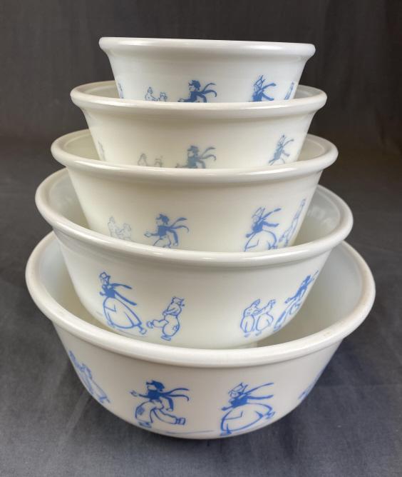 Set of 5 Hazel-Atlas Dutch Skater Nesting Bowls: Blue on white milk glass the largest measures approximately 9 1/4" in diameter. Some wear as shown on some of the bowls.