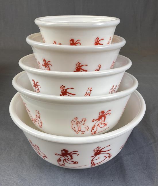 Hazel-Atlas Dutch Skater Set Of 5 Nesting Bowls: Red on white milk glass. The largest measures approximately 9" in diameter.