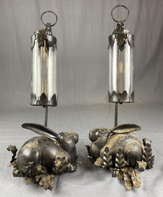 Pair Vintage Cast Iron Bunny Candle Sconces: Midcentury cast and wrought iron candle sconces with glass hurricane shades. Each measures approximately 10" wide and 22" long. They have been used outdoors and show the expected patina and wear, they