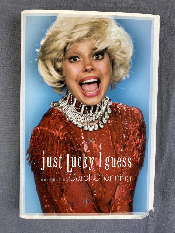 Carole Channing "Just Lucky I Guess" Signed 1st Ed: Hardcover with dust jacket and signed. Unfortunately the lower right corner appears to have been chewed as shown.