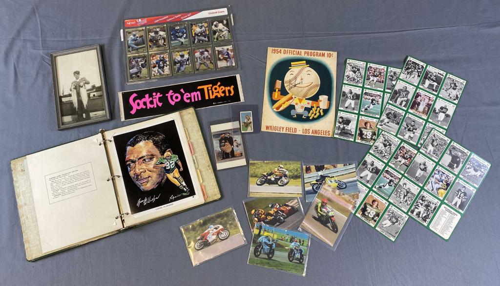 Collection of Sports Themed Ephemera: Includes an autographed 1954 baseball program, a set of 1990 Detroit Lions football cards, 4 sheets of 1990 Michigan State football cards, a baseball cigarette card, an album of Green Bay portraits an