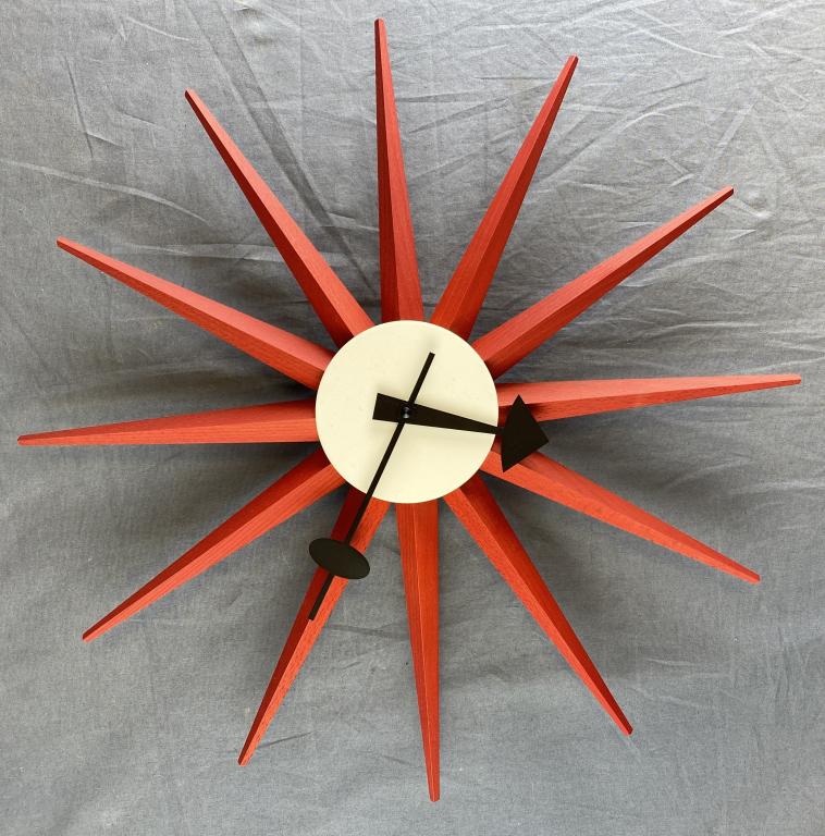 George Nelson Red Sunburst Clock Vitra Museum: From the Vitra Design Museum, George Nelson's original design with a certificate of authenticity. Measures approximately 18 1/2" across. Battery operated and appears to be ticking but has not been ful