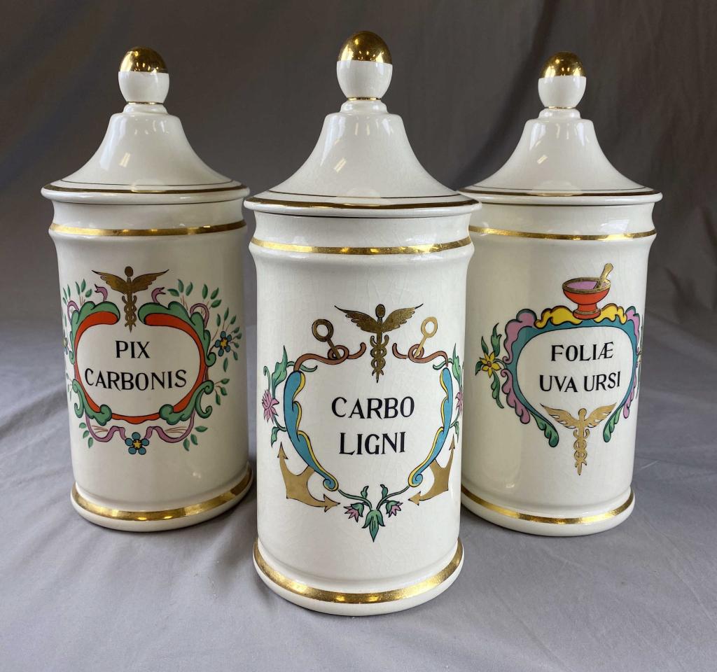 3 Jeanne Robinette Porcelain Apothecary Jars: H. 11 1/2" Condition: 2 of the lids have repaired breaks as shown. Overall crazing. SHIPPING: In House Shipping Available.