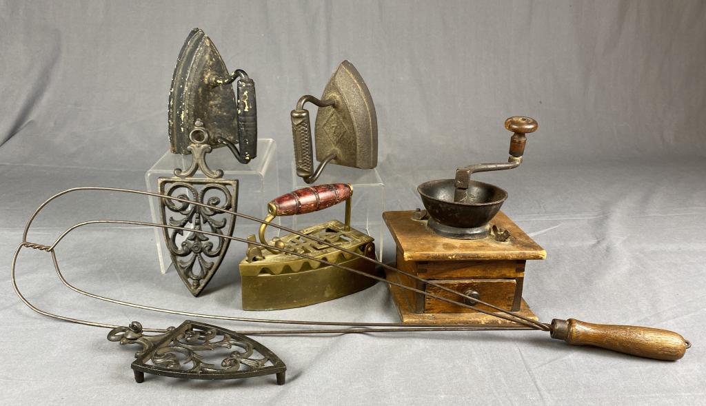 Group of Antique and Vintage Kitchen Items REO: From an estate of the family of R.E. Olds of Lansing Michigan. Includes a coffee grinder 3 irons, 2 iron trivets and a carpet beater. The carpet beater measures approximately 30" long. SHIPPING: In Ho