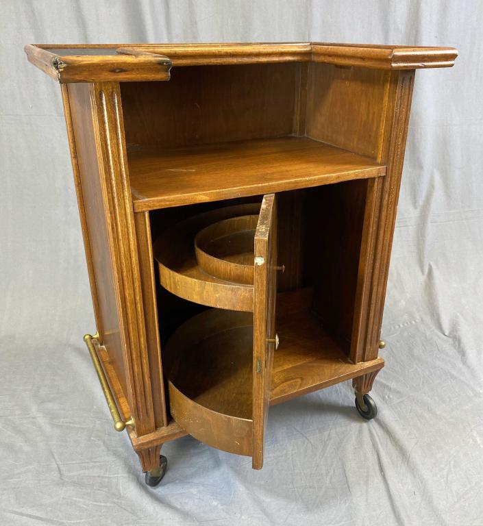 Circa 1960s Portable Bar Liquor Cabinet: Midcentury modern walnut portable bar with a revolving liquor cabinet and brass rails. The key is missing and not included. Some damage, see photos for details on condition. H.34" W. 27" D. 19" Condit