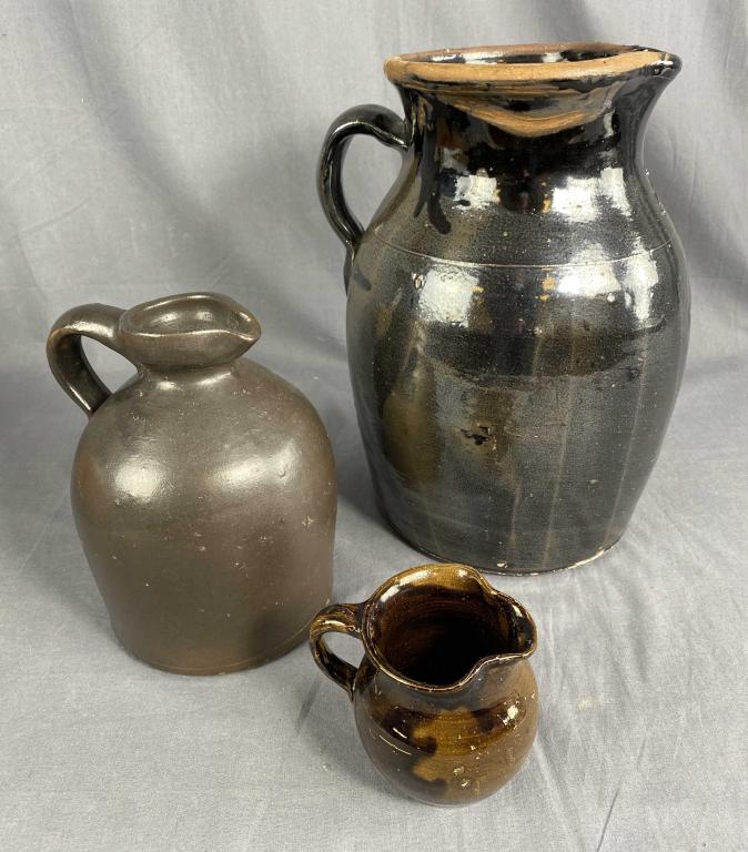 3 Brown Glazed Earthenware Jugs: The tallest measures 13". It has some damage at the top as shown. SHIPPING: In House Shipping Available.