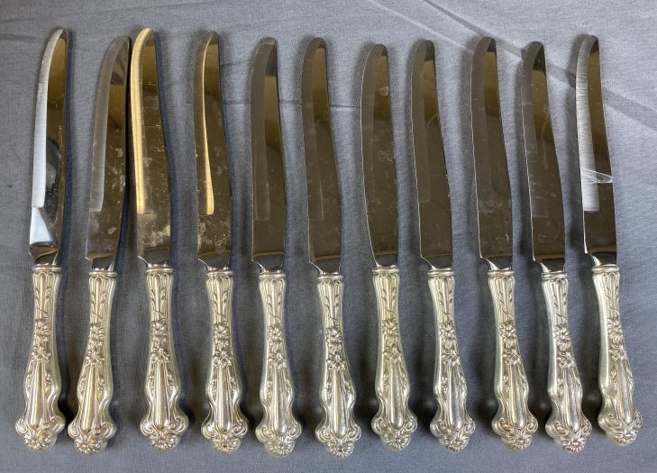 Group of 11 Sterling Silver Handled Dinner Knives: 24.2 ounces total weight including the blades. From an estate of the family of R.E. Olds of Lansing Michigan.