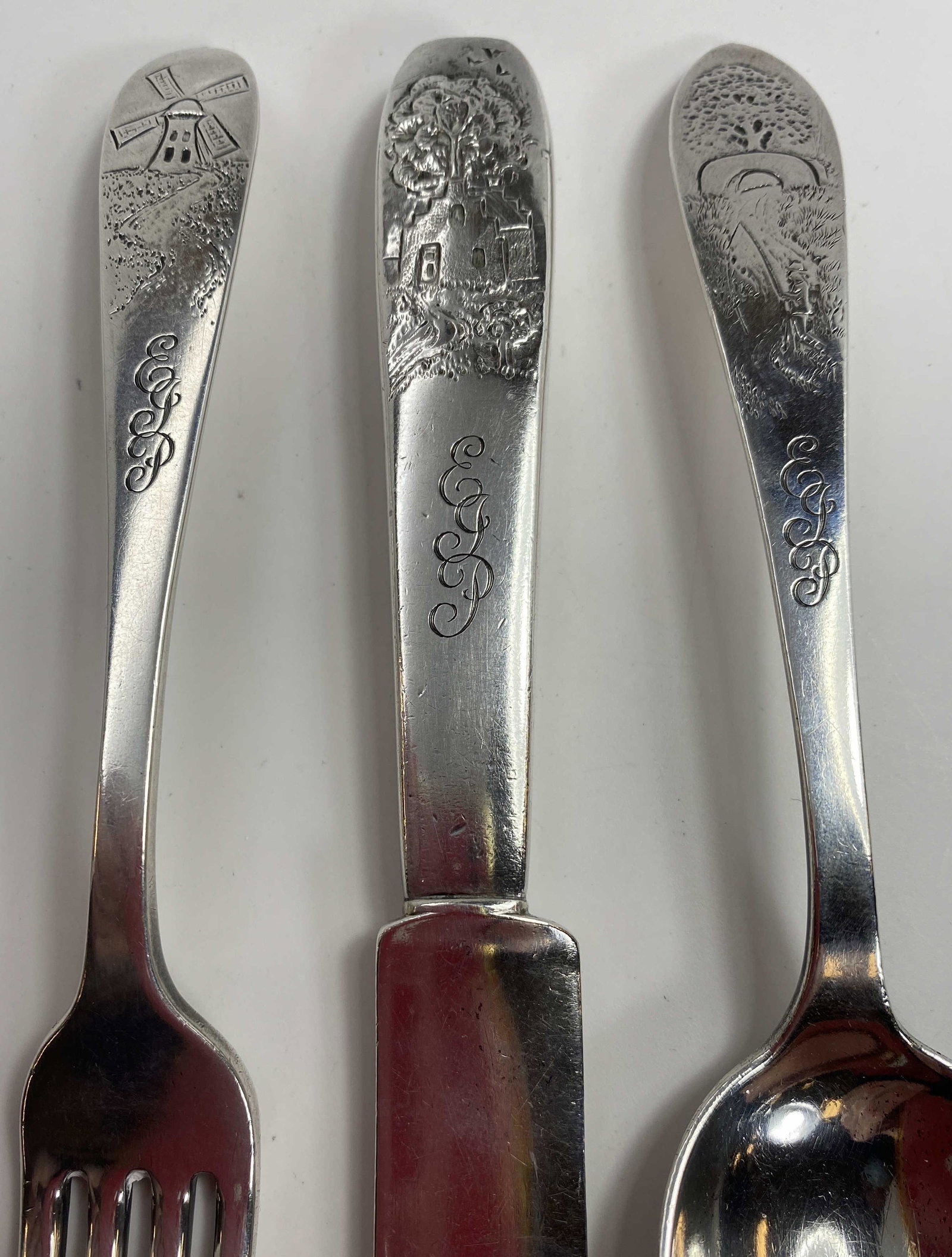 Tiffany & Co. Childrens Sterling Flatware Set: Nursery flatware set in sterling silver. It has the John C. Moore mark "M" as well as the Tiffany mark. It is in a Dutch country pattern. Includes a fork, a knife and a spoon. The total weight of the 