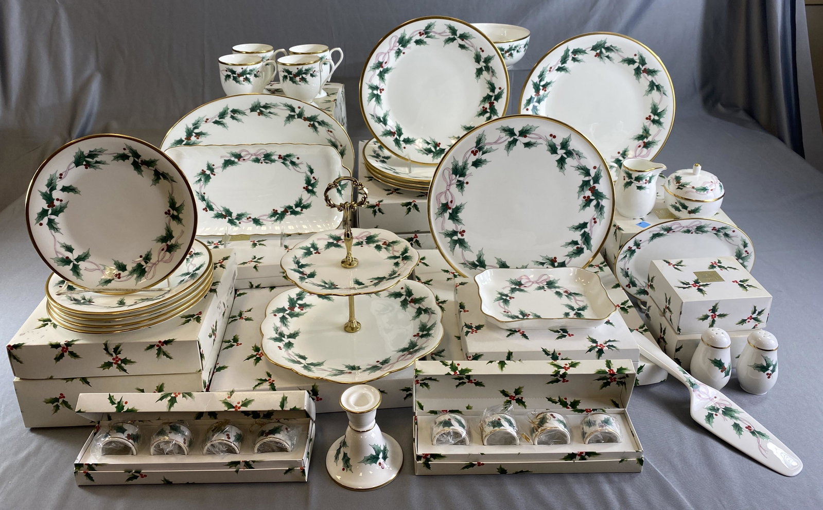 Mikasa "Ribbon Holly" Holiday Bone China Service: Service for 8 with extras and serving pieces. Includes: (2) 12" buffet platters, (1) cake plate, (1) 2-tier tidbit, (1) sandwich tray, (1) 14" oval platter, (1) Chelsea tray, (2) 8 1/2" round vegetabl