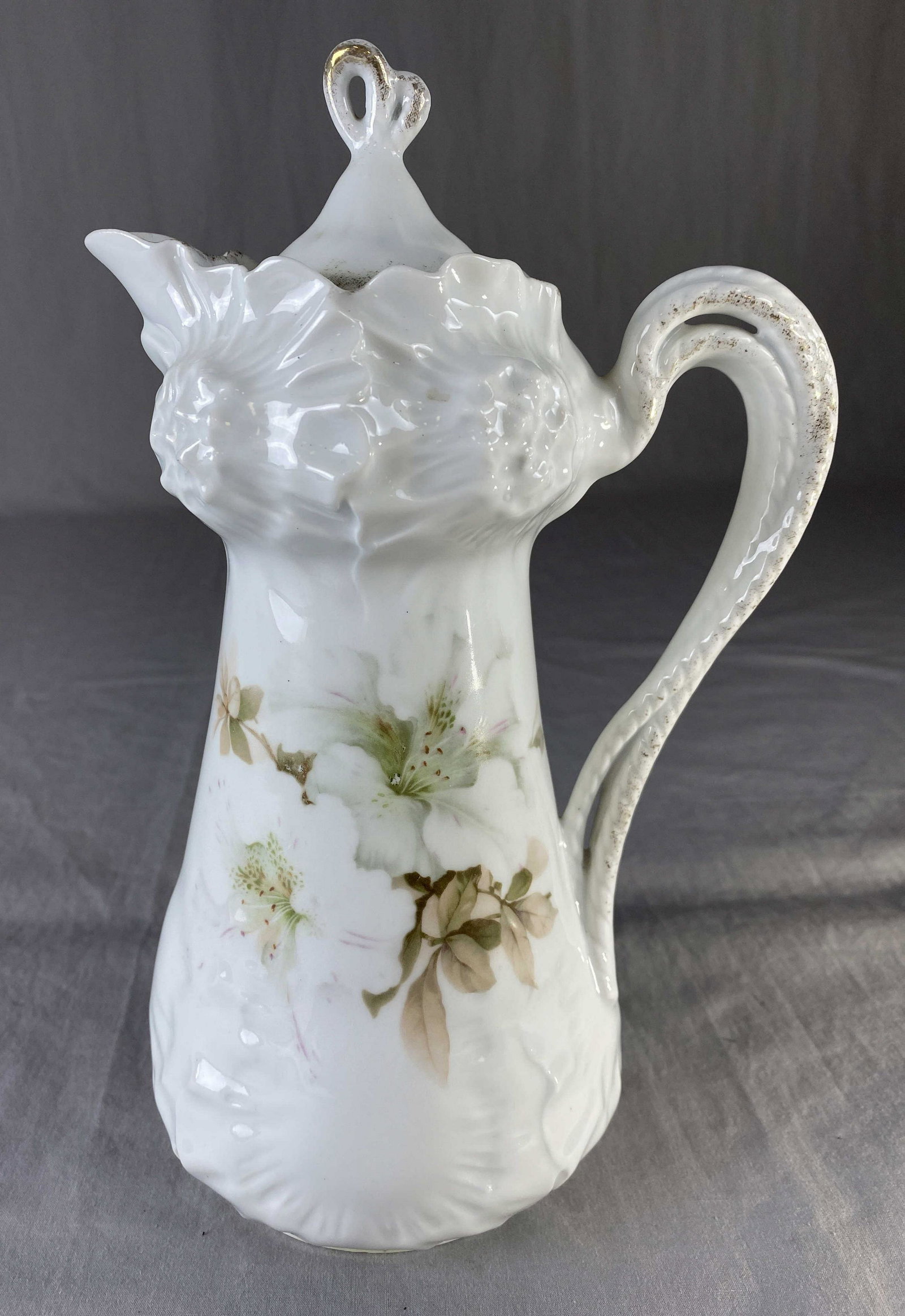 RS Germany Porcelain Chocolate Pot White Flowers: A lovely design with embossed and transferred floral motifs. It measures 10" tall.