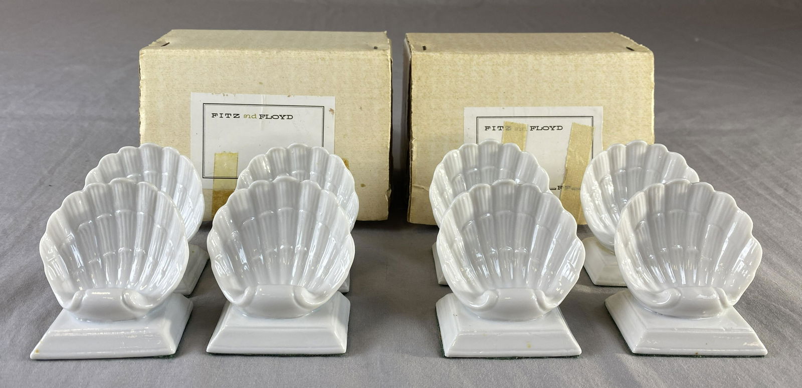 8 Fitz & Floyd Porcelain Shell Place Card Holders: White porcelain place card holders from Fitz & Floyd. Each measures 2 1/2" tall.