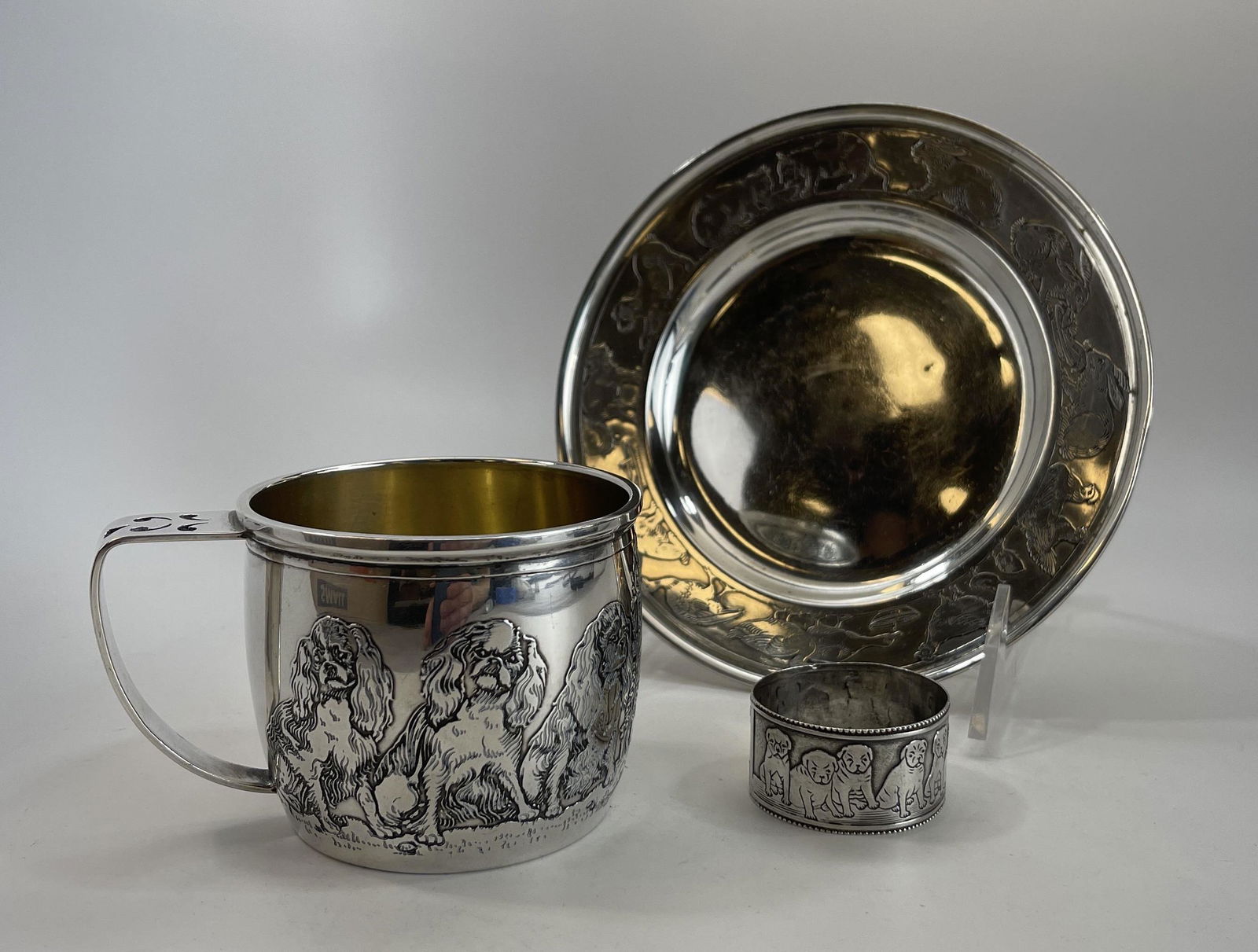 R. Blackington/Gorham "Pets" Sterling Child’s Set: Includes plate, cup, and napkin ring. The plate measures 5 3/4" and weighs 106 grams The cup measures 2 1/2" tall and weighs 120 grams The napkin ring is 1 1/2" in diameter and weighs 14 grams. The pl