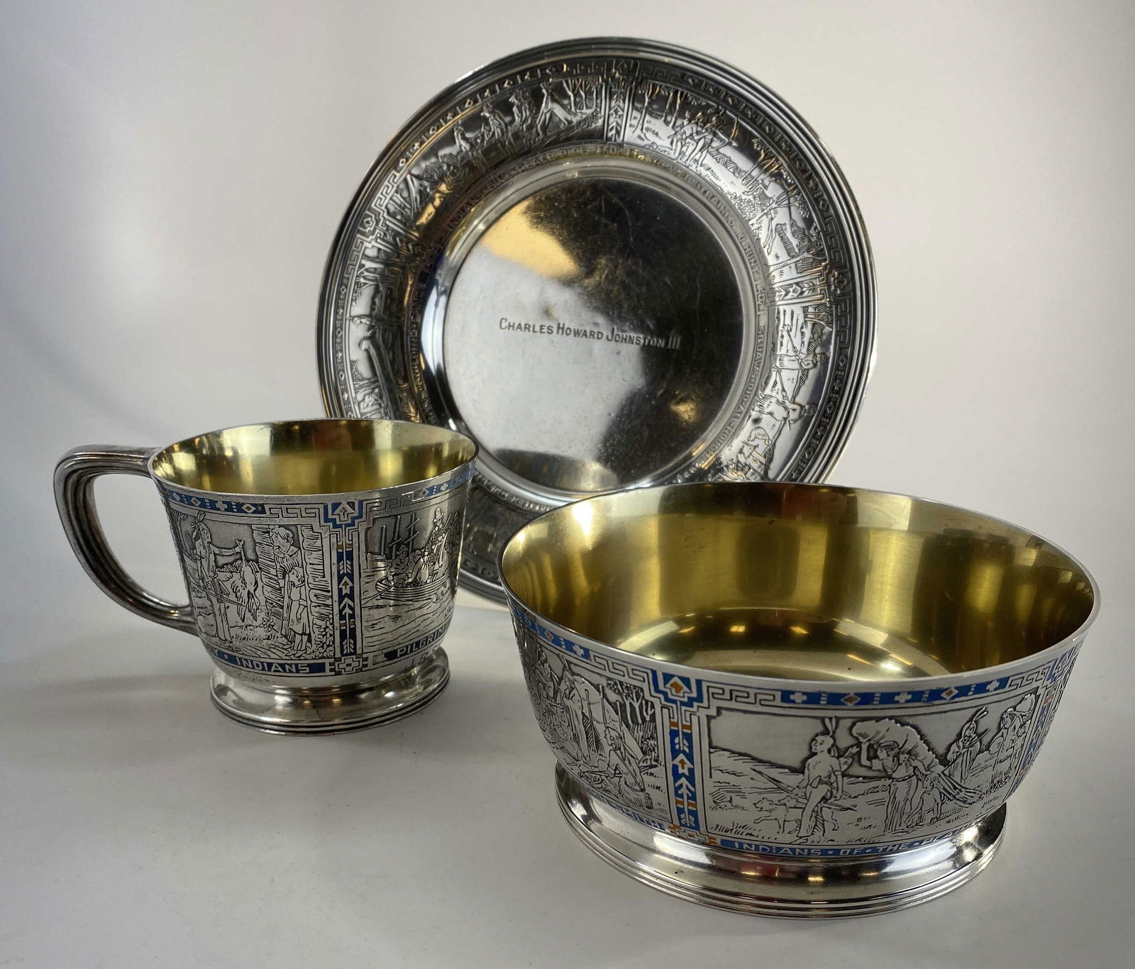 R. Blackington Sterling Thanksgiving Child's Set: R Blackington Sterling Silver Child's set in a Thanksgiving pattern including a plate, bowl and cup. The cup and bowl featuring turquoise and gold enamel decoration. The plate measures approximately 6