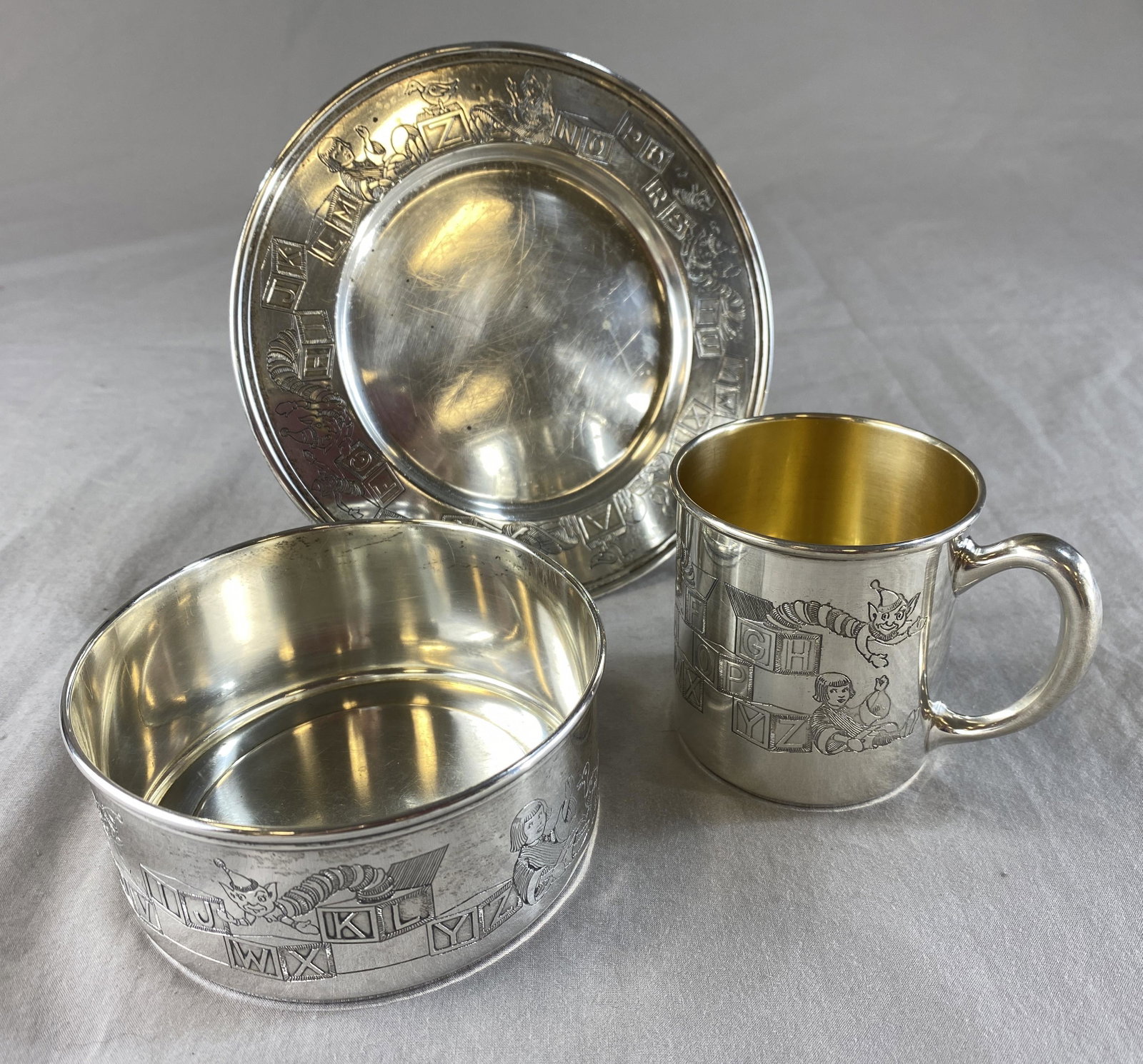 R. Blackington Sterling Nursery Set - Toys, Blocks: According to the marks, the cup appears to be from the R. Blackington Co. and the plate and bowl from the H.R. Morss Co. All are marked sterling and decorated in an identical toys and blocks design. I